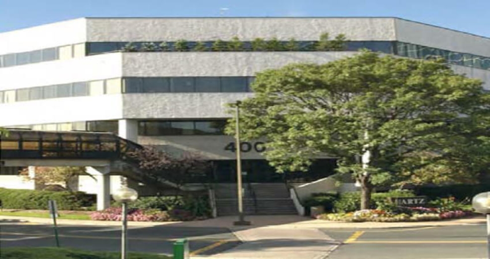 a building at 400 Plaza Drive with a bridge connecting to the entrance