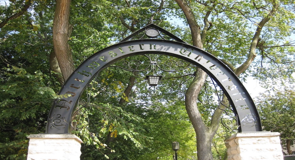 an arched sign in a park