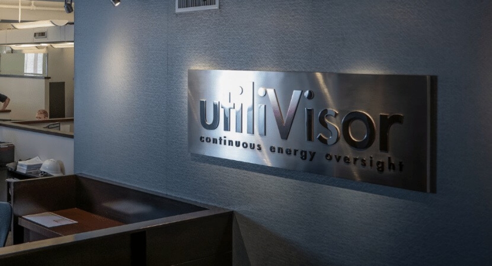 a sign of the utiliVisor logo on the office wall