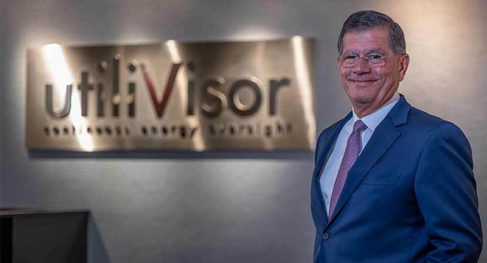 Richard Angerame, CEO of utiliVisor, standing in front of company sign